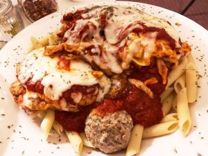 The Tuscan trio is huge. The pasta dish ($14.95) was the perfect portion size for three people. Maybe four. The bottom of the plate was covered in penne. On top of the bed of pasta sat two meatballs, sausage lasagna and chicken parm.