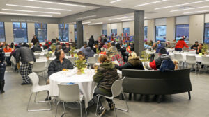 The main dining room of the Clarence L. Jordan Food Service and Culinary Education Center in Syracuse seen during a holiday celebration for clients last year. In 2019, the Rescue Mission completed a $5.8 million expansion of the facility, which serves meals year round to anyone in need. During the pandemic, the Mission has had to adjust how it serves up to 700 meals a day to clients to ensure everyone’s health and safety. 