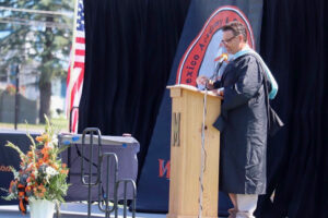 Michael Charbonneau, on senior recognition day, speaking at commencement, and with a class of his students. 