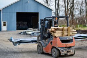 A forklift moves metal roofing at New Haven Building Supply. 